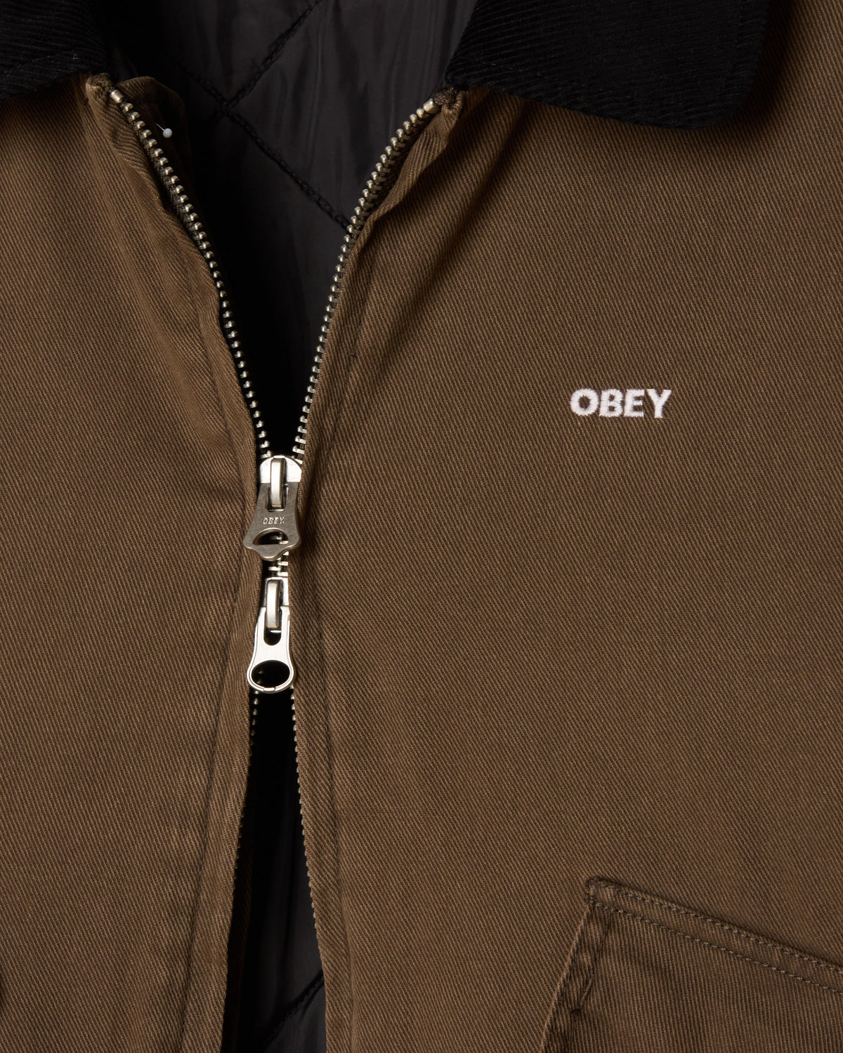 Brown jacket with a zipper and 'OBEY' logo on a black background
