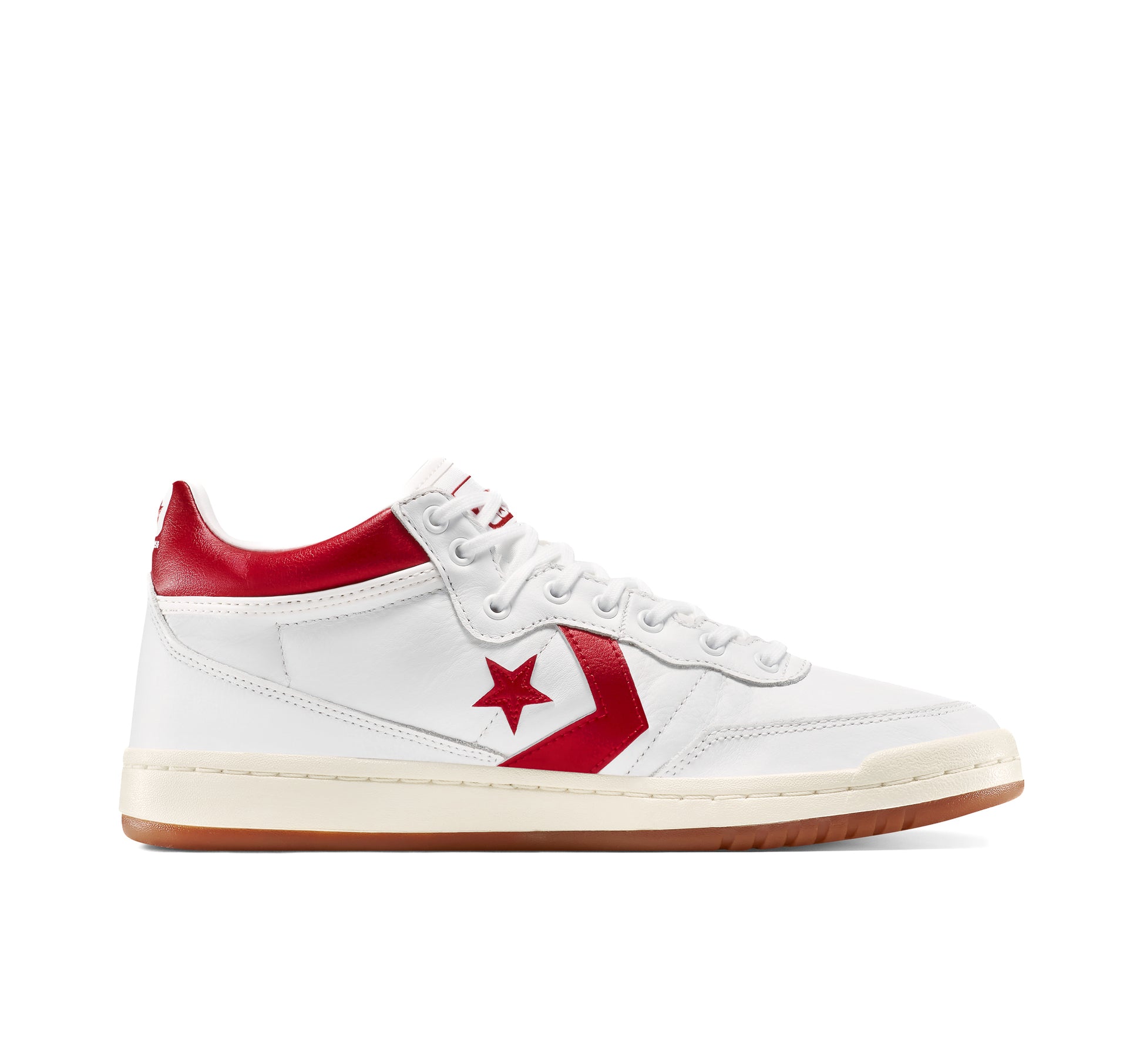 White converse sneaker with red accents on a white background