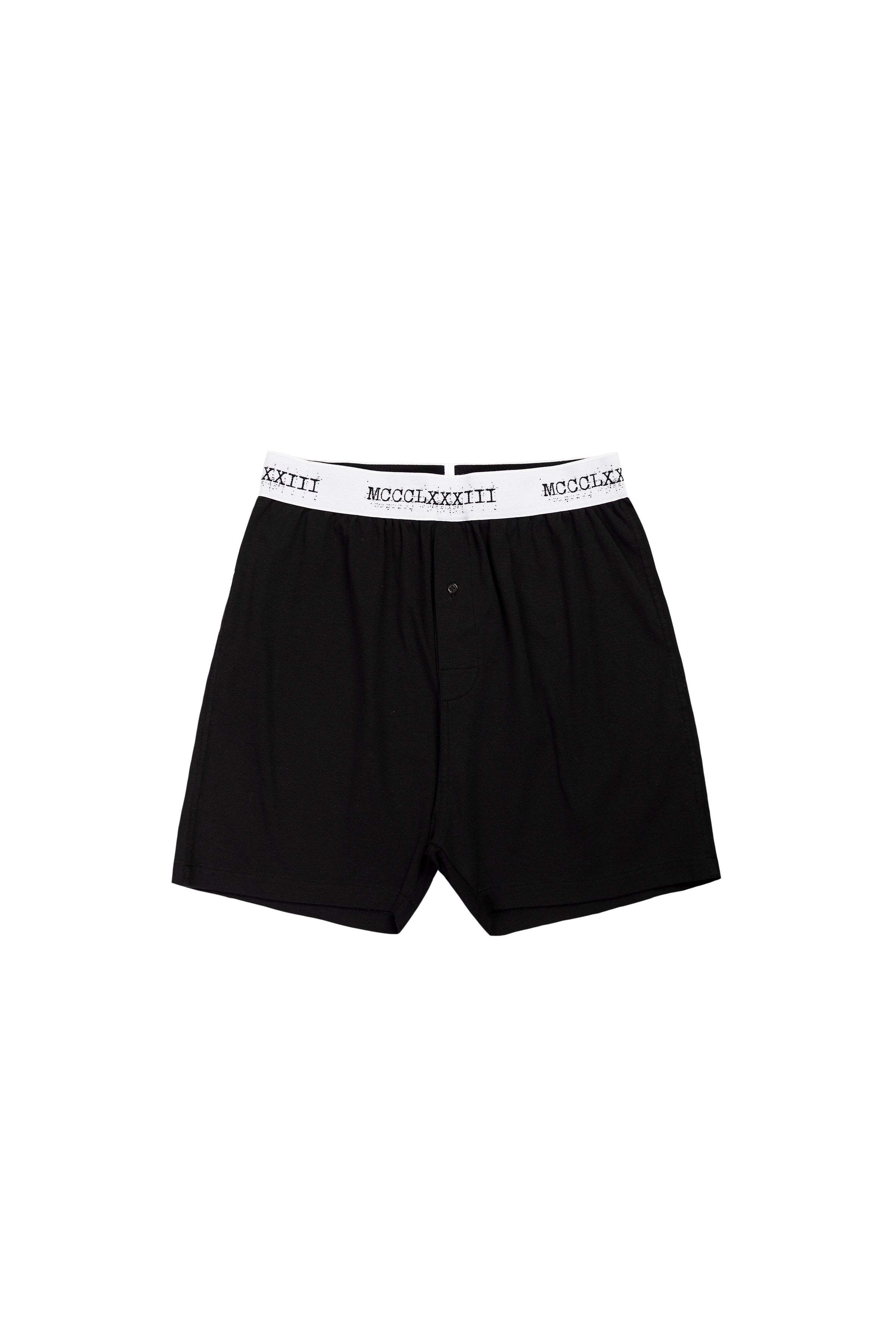 Black boxer briefs with white waistband on a white background
