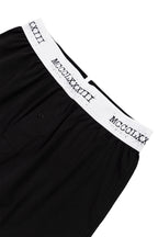 Black boxers
 with white waistband featuring Roman numerals on a white background