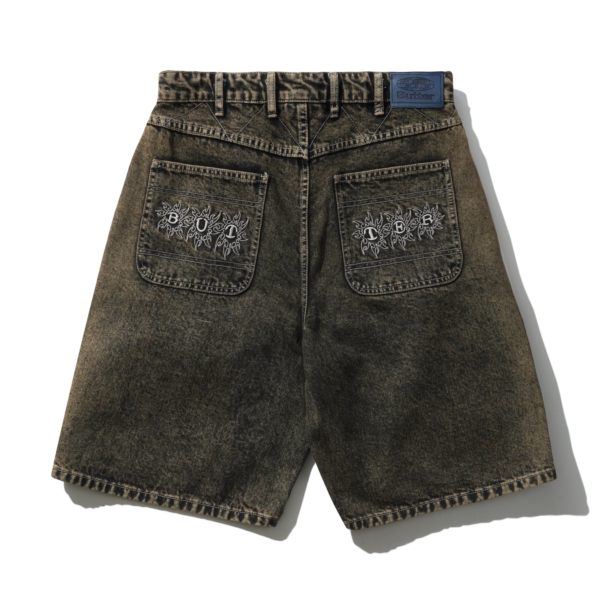 Brown denim shorts with embroidered designs on a white background