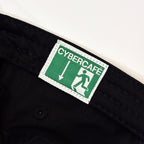Close-up of a black woven textile item, likely a belt or strap, featuring a rectangular green and white CyberCafe label sewn onto the inside.