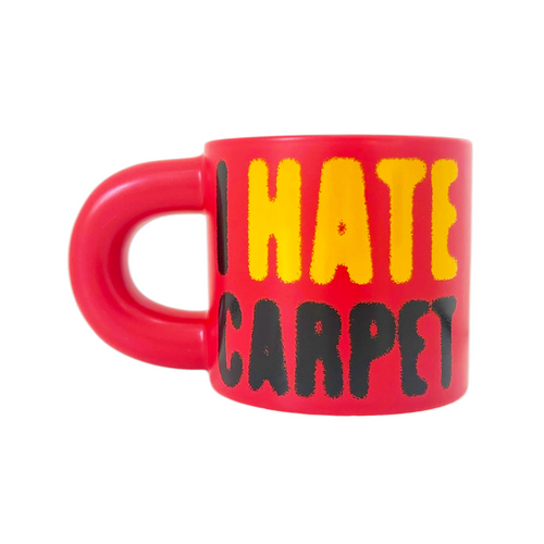 Red mug with yellow and black text 'I HATE CARPET' on a white background