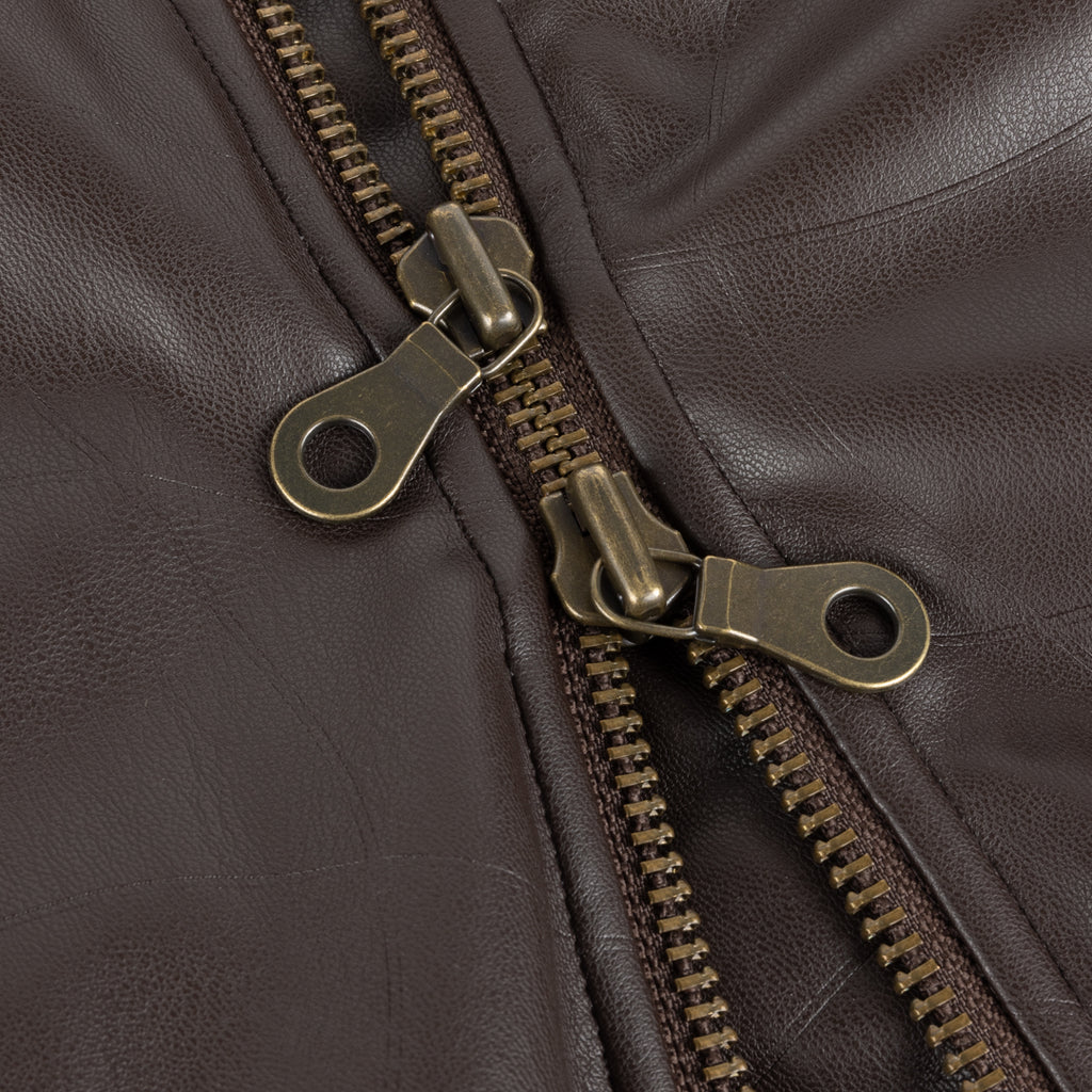 Close-up of a brown leather jacket with a zipper