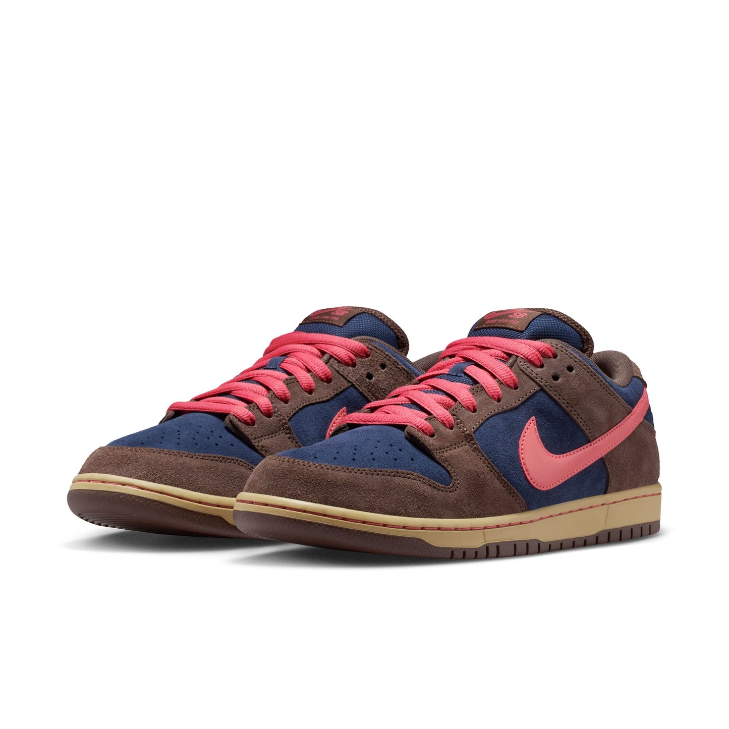 Pair of brown and blue sneakers with pink laces on a white background