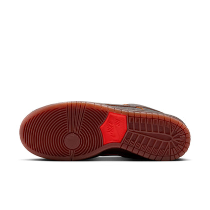Brown shoe sole with red accent on a white background