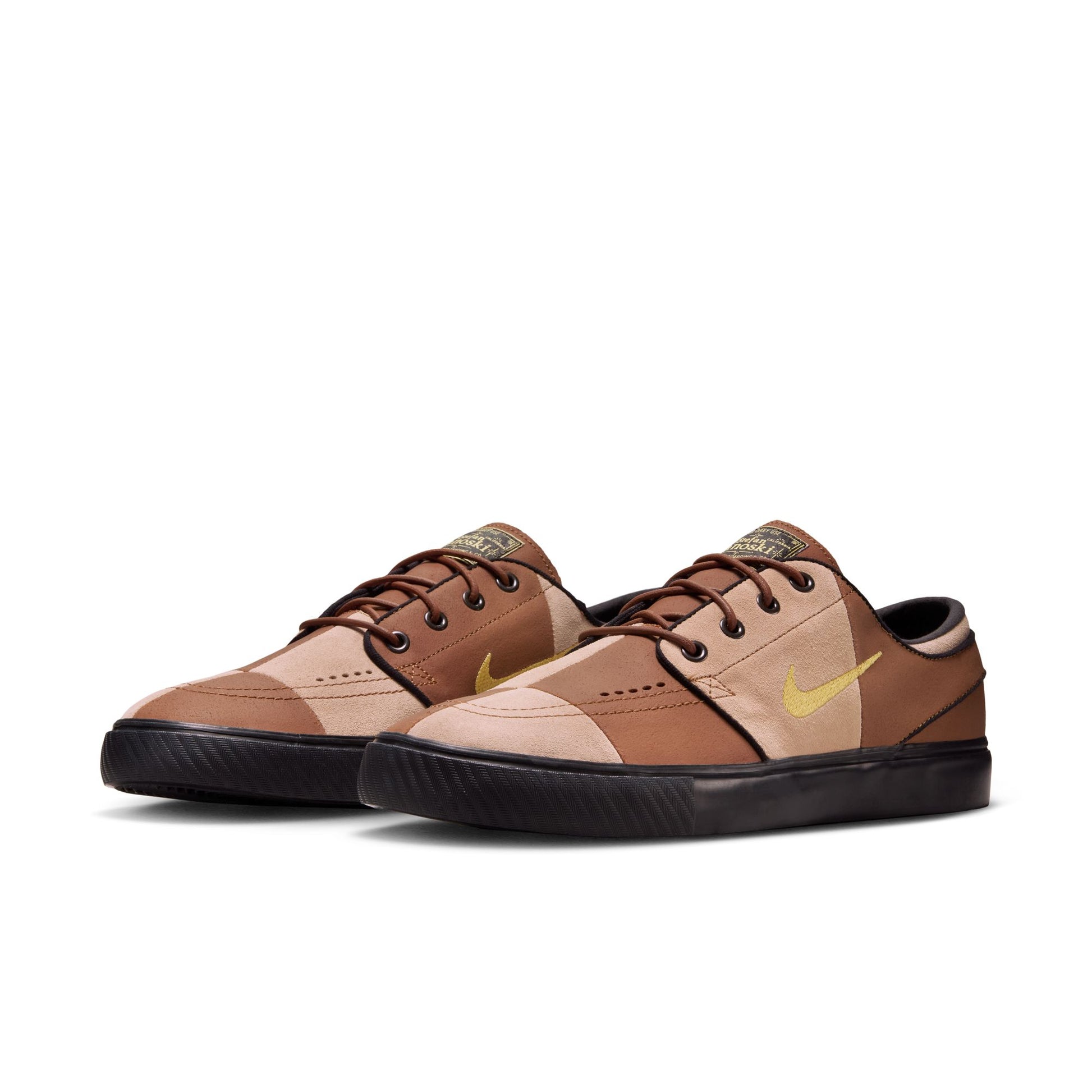 Brown and beige sneakers with a Nike logo on a white background