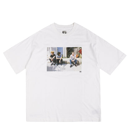 White t-shirt with a graphic of 3 people on a white background
