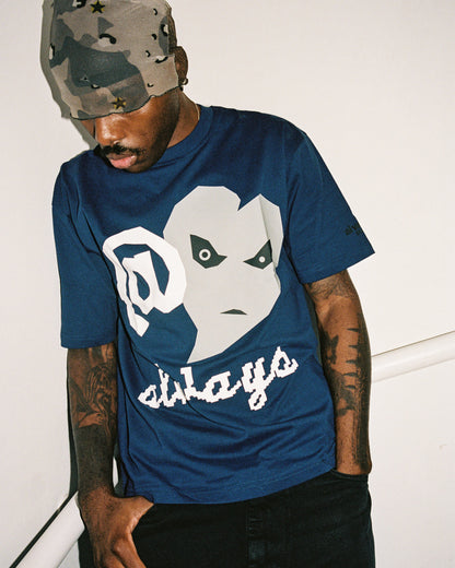 Person wearing a blue t-shirt with a graphic design and text, standing against a white background.