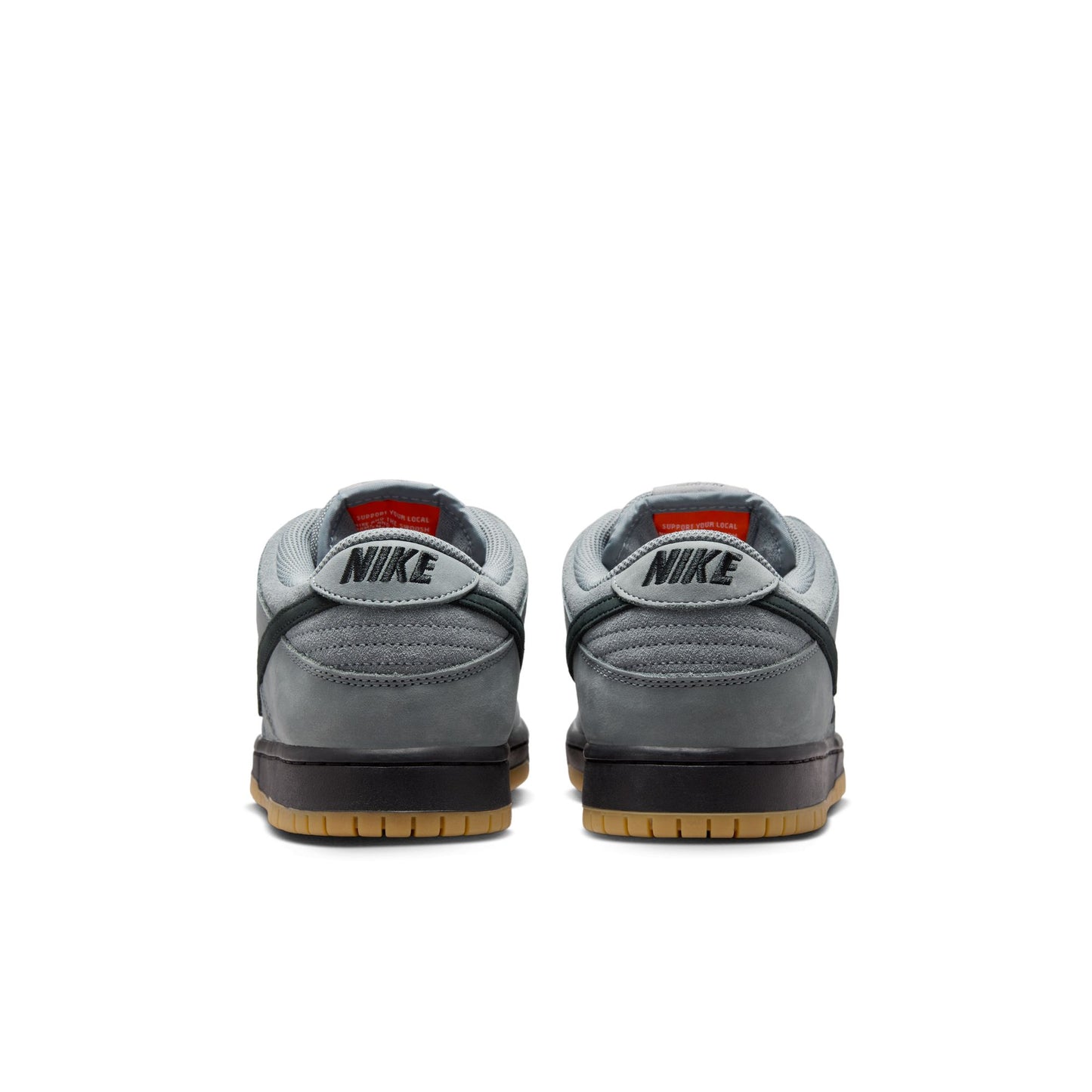 Gray Nike sneakers with black soles on a white background