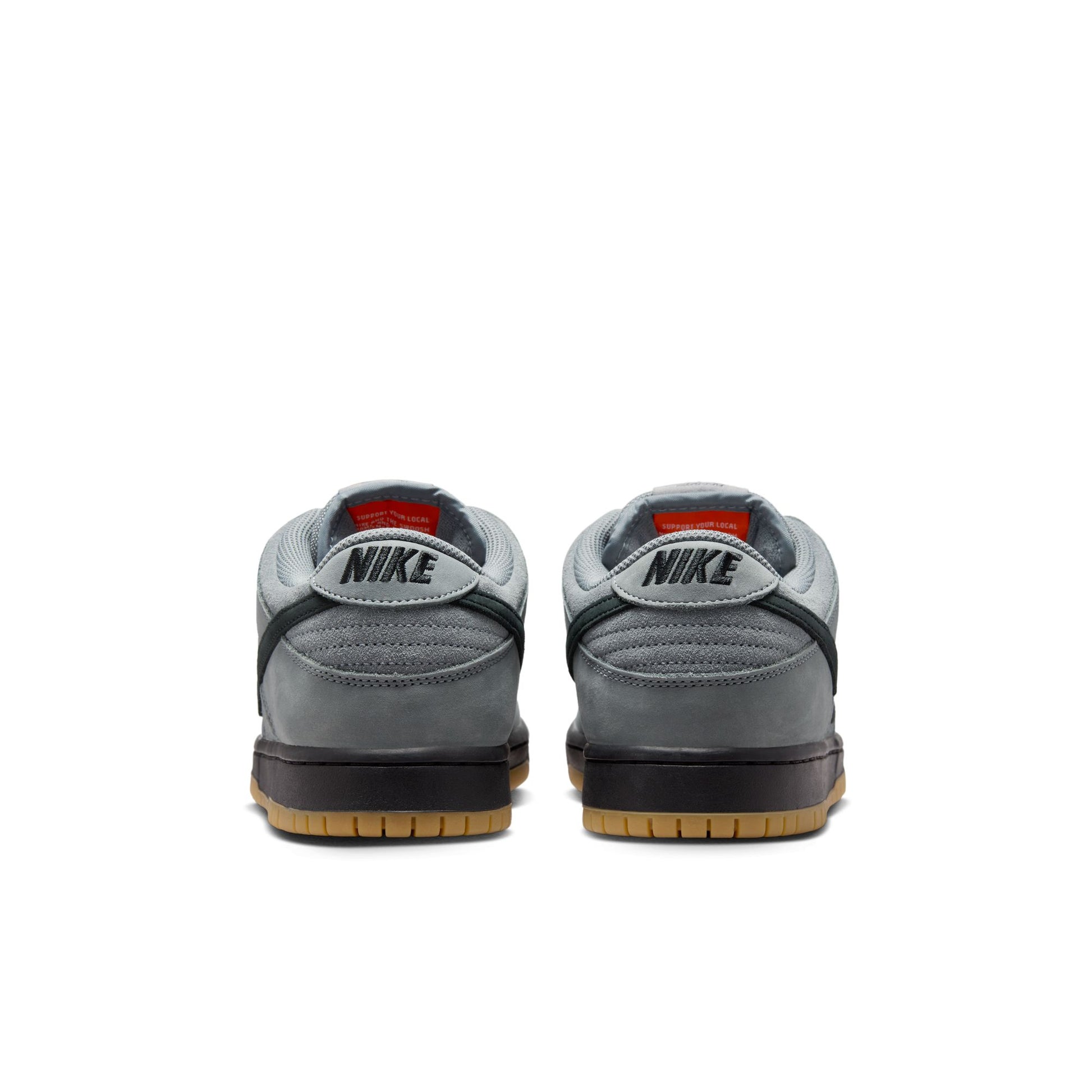 Gray Nike sneakers with black soles on a white background