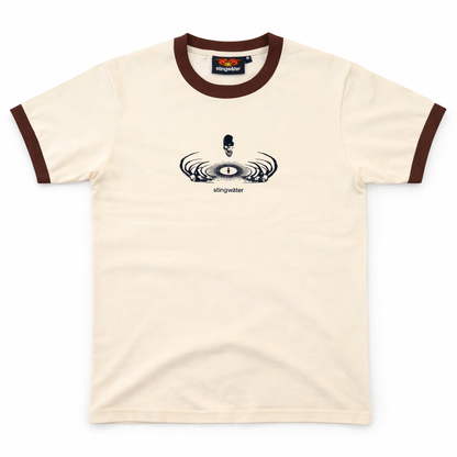 Beige t-shirt with brown trim featuring a logo on a white background
