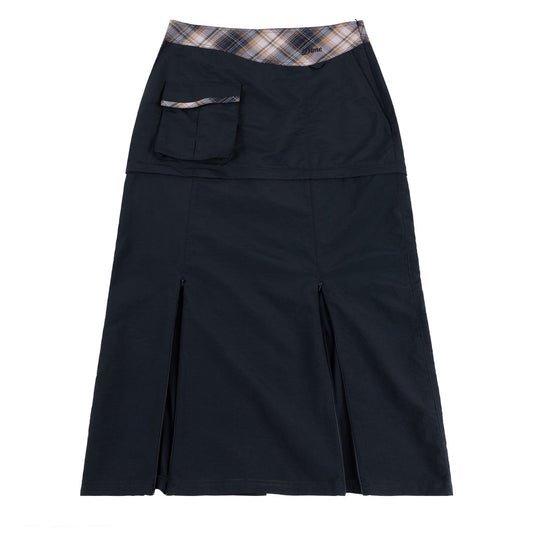 Dime Tech Skirt in plaid navy shown on model, featuring cargo pocket and front slit